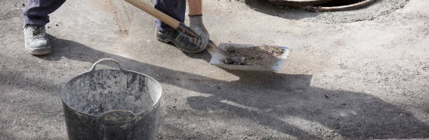 istock operator in uniform finishes cleaning process with a shovel, electrical records urban road on asphalt 1448538410