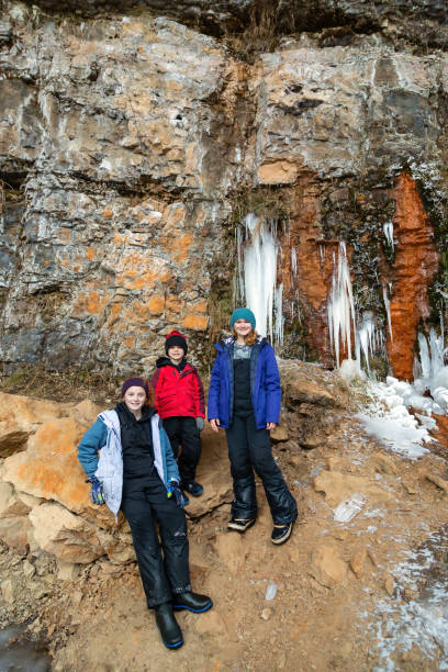 istock Three Kids Exploring Riverbank in Winter 1448542250