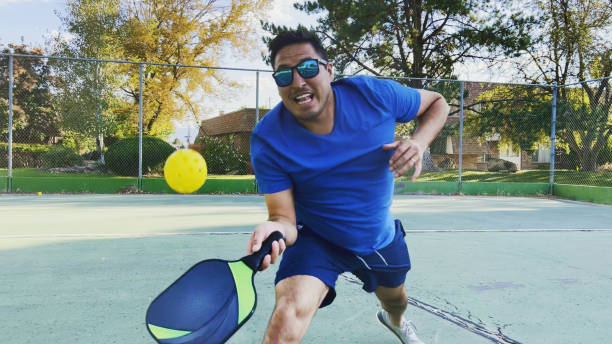 Colombian American Hispanic Couple Playing Pickle-ball on Sunny Autumn Day Photo Series stock photo