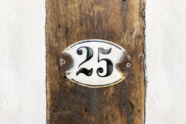 istock house number twenty-five 25 plaque on wall 1448547349