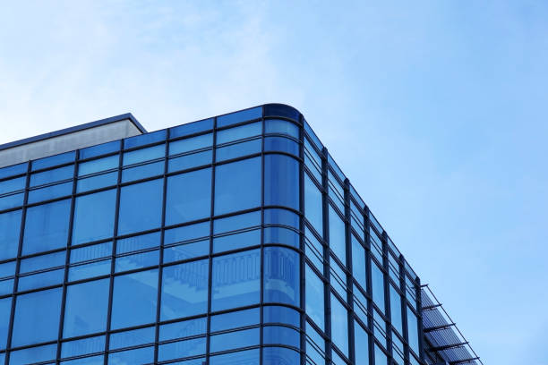 istock modern glass facade office building against blue sky 1448547380