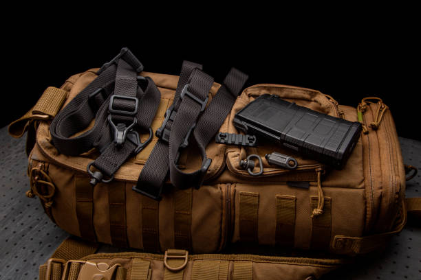 istock A black nylon weapon belt on a brown military backpack. Dark background. 1448547486