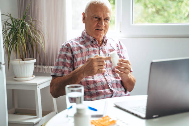 Senior man make distant video call communicating with doctor online. stock photo