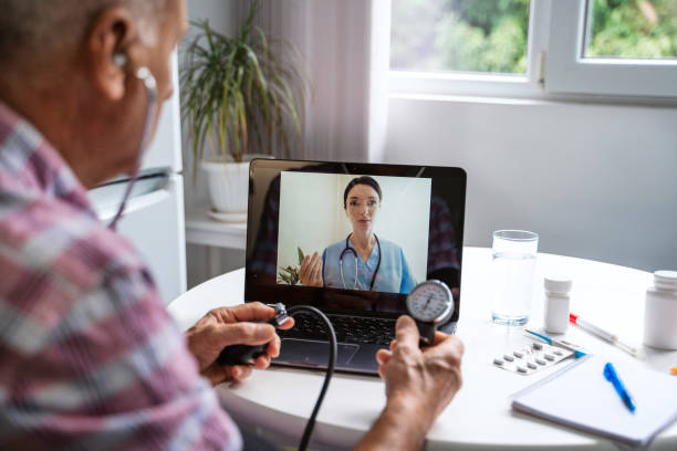 Senior man make distant video call communicating with doctor online. stock photo