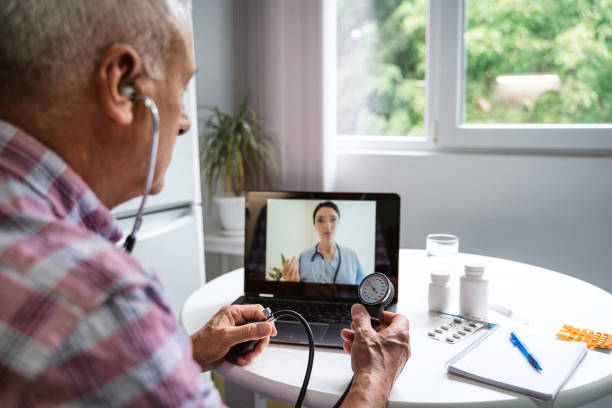 istock Senior man make distant video call communicating with doctor online. 1448547975