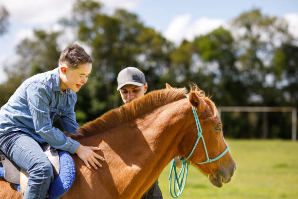 istock Down syndrome boy experiencing a horse ride for the first time 1448548116