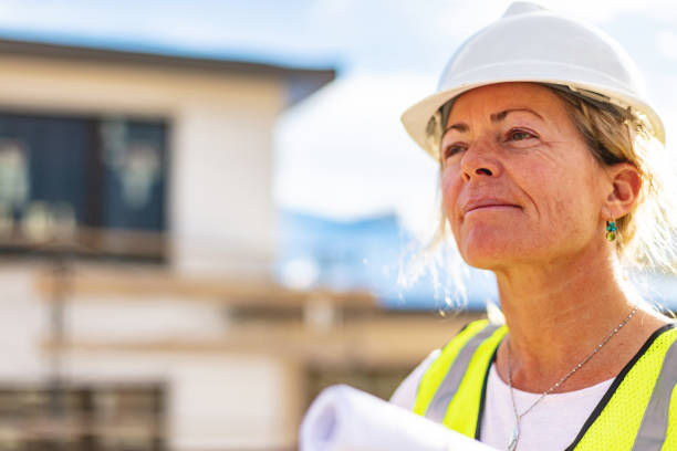 Residential Home Development Female Contractor with Blueprints on Job Site Photo Series stock photo