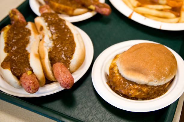 Cheese burger and hot dogs smothered with chili sauce