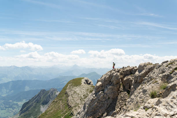 istock Man standing on the top of a mountain with a beautiful panoramic view. 1448552809