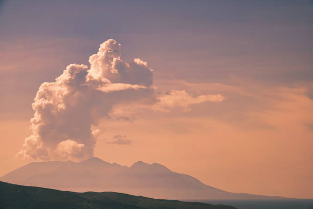 Huge white clouds over the mountains and sea with volcanic mountain view Samothrace island Greece. Shot from Gökçeada Imbros Island 37 km  away from Gökçeada, Turkey. Turkey's westernmost border