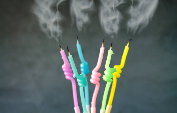 istock Birthday candles with flame blown out smoke on dark background 1448553853