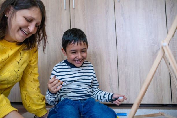 istock Aunt and nephew having fun in front of a whiteboard. 1448554049