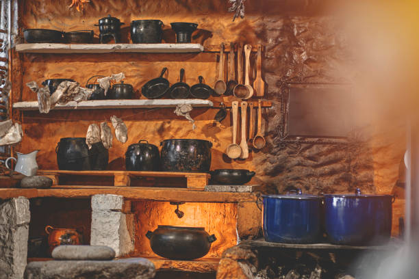istock Cast iron pot with fresh herbs, spices and kitchen utensils for tasty cooking on rustic table. Homemade cooking. Dark. 1448554962