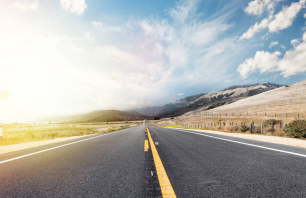 istock Asphalt road and country landscape with sunny sky 1448555633