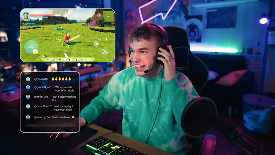 Hyped Streamer Playing a Video Game Online. Stylish Man Streaming MMO Gameplay from Home in Living Room Apartment. Followers Engaging Through Interface During Live Broadcast on Internet.