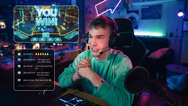 istock Excited Streamer Playing a Video Game Online. Stylish Man Streaming His Gaming Process from Home Apartment in Living Room. Followers Engaging Through Interface During Live Broadcast on Internet. 1448556449
