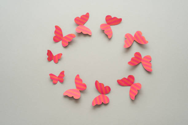 istock Circle made of butterflies on a grey background. 1448557108