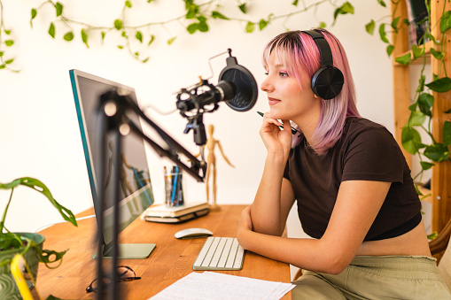 Young woman with colored hair recording podcast