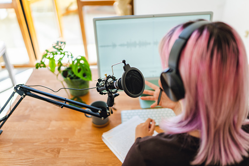 Young Woman Recording  Audio For Online Podcast