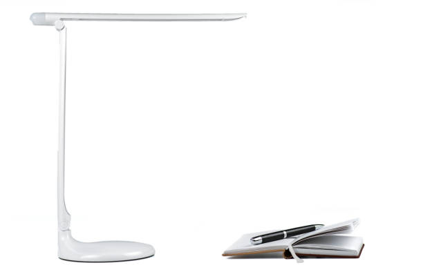 istock Open a diary with a pen on the table under the desktop LED lamp 1448557717