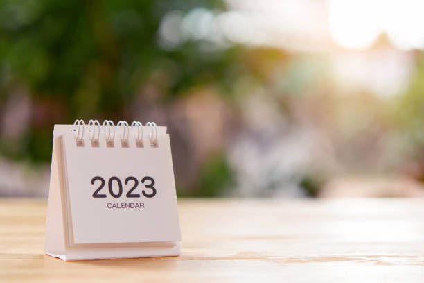 istock 2023 Desk calendar on wooden table. Copy space 1448557760