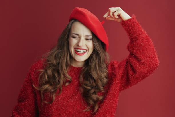 istock smiling elegant woman in red sweater and beret 1448557867