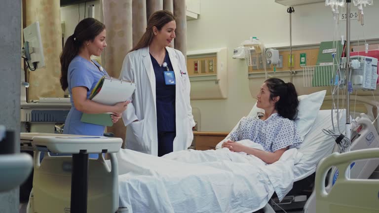 Doctor and nurse talk with hospital patient