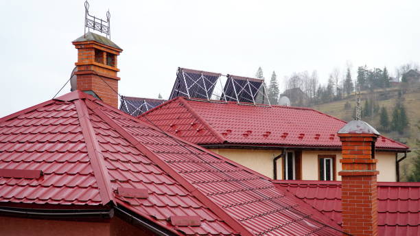 istock Solar glass tube hot water panel array mounted on a tiled roof. water heating batteries. 1448558871