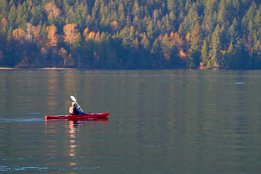 A kayaker paddling on Cultus Lake BC, Canada near Chilliwack. Chilliwack, British Columbia, Canada. November 2, 2019.