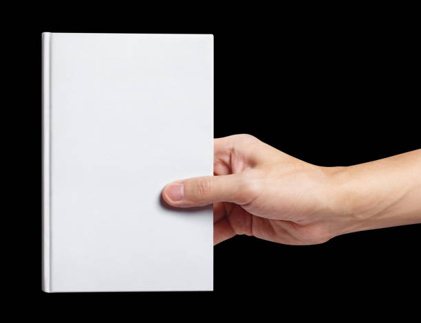 istock Hand holding a blank white hard cover book, on black 1448565019
