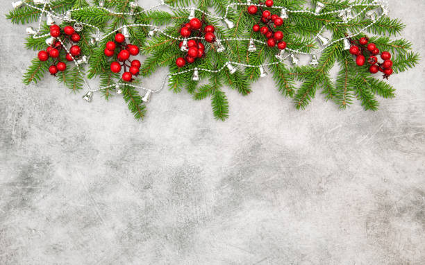 istock Christmas tree branches red berries  silver garland decoration 1448565848