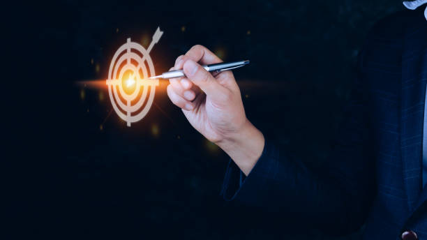 istock Businessman touching virtual dartboard with arrow ,Business Achievement objective target concept.for setup business objective target concept. 1448566694