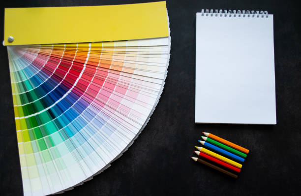 istock Paper fan paint swatch interior design, wall painting. Black background. White notebook, multicolored pencils, copy space 1448568909