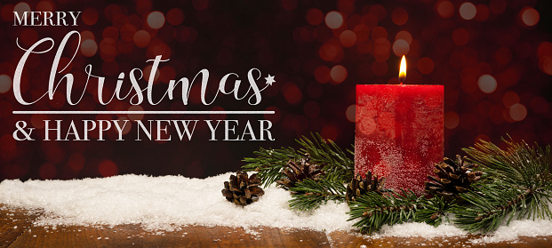 Merry Christmas & Happy new Year celebration holiday background banner greeting card - Red candle candlelight, pine branch and pine cones on snowy wooden table with blurred bokeh in the night