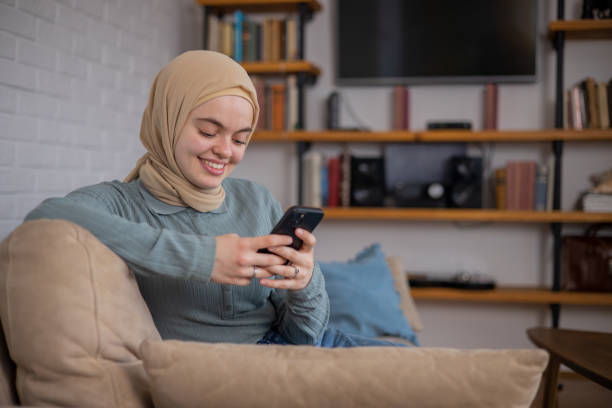 istock Happy young woman using phone 1448572421