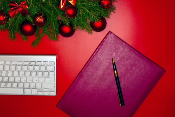 istock Christmas decorations and a business folder for signing contracts. On a red background . 1448574071