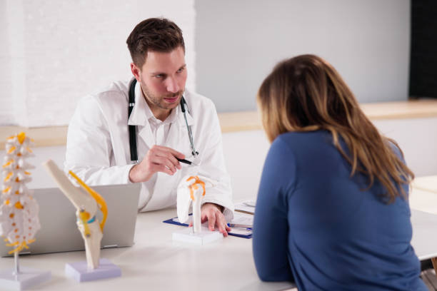 istock Chiropractor Doctor Consultation In Physiotherapy Clinic 1448574127