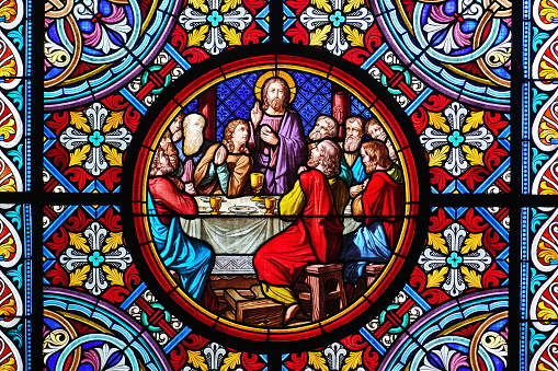 Basel Cathedral Minster. Stained glass window. The Last Supper is the final meal that Jesus shared with his Apostles. Basel, Switzerland - December 2022