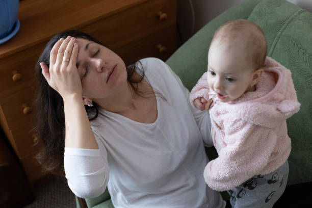 istock The mother experiences a headache while caring for the child. 1448577586