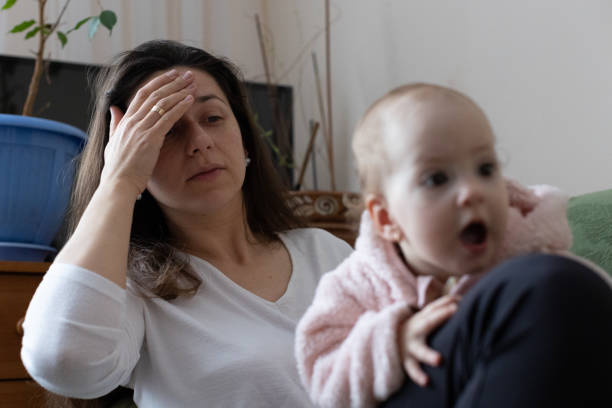 istock The mother experiences a headache while caring for the child. 1448577588