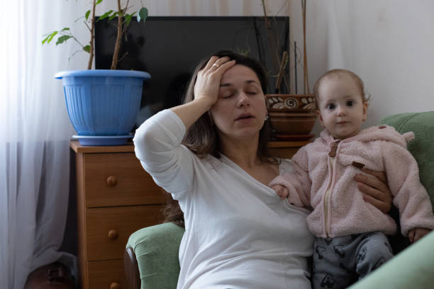 istock The mother experiences a headache while caring for the child. 1448579219