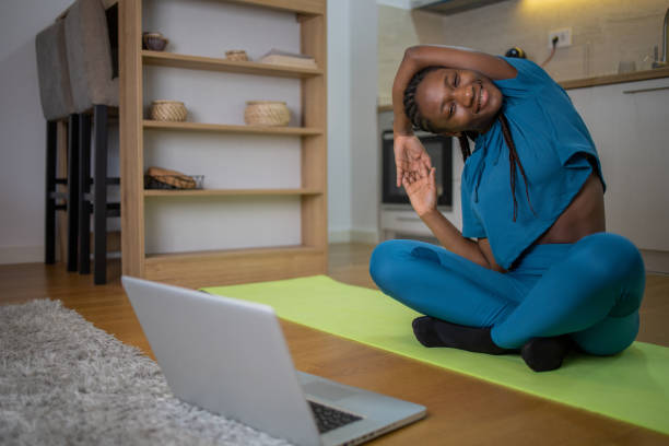 istock Young woman at home keeping fit by exercising 1448580598
