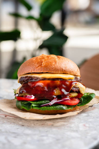 istock Double cheeseburger with a lot of sauces - close up view 1448582783