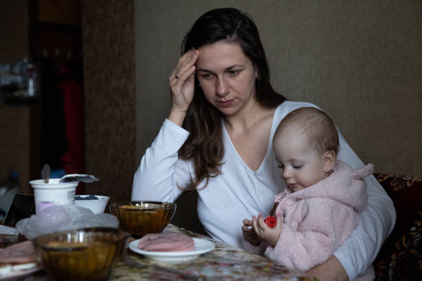 istock The mother experiences a headache while having lunch with her daughter in the kitchen. 1448583657