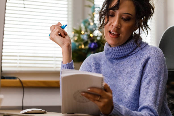 istock Young woman brainstorming ideas while working at her desk at the office during Christmas holidays 1448584114