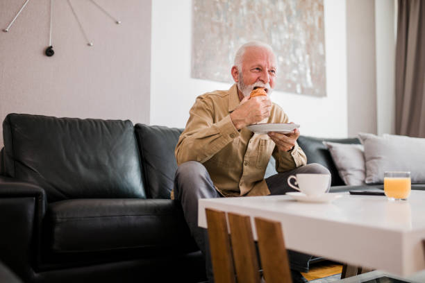 istock Senior man having breakfast at home 1448584725