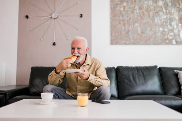 istock Senior man having breakfast at home 1448584729