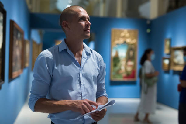 istock Man standing in picture gallery 1448584966