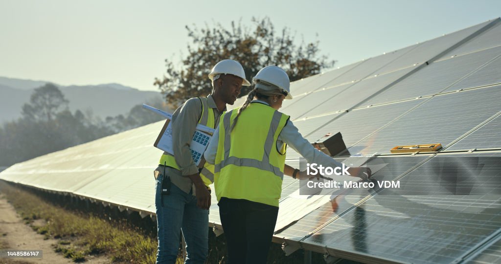 Solar energy, engineering and planning blueprint for construction, architecture project and roof building. Builder, electrician and solar panels industry, teamwork and collaboration in sustainability Solar Energy Stock Photo
