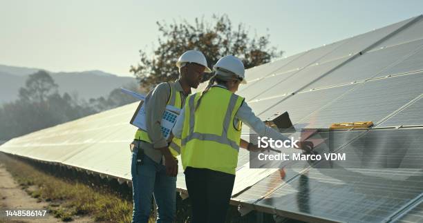 Solar Energy Engineering And Planning Blueprint For Construction Architecture Project And Roof Building Builder Electrician And Solar Panels Industry Teamwork And Collaboration In Sustainability Stock Photo - Download Image Now
